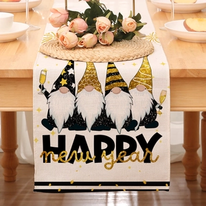 Linen Happy New Year table runner detail with festive gnomes on a rustic wooden dining table