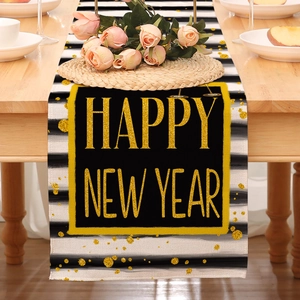 Close-up of Happy New Year table runner with black stripes and gold sequin lettering