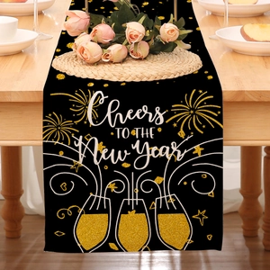 Detail of linen Happy New Year table runner with gold fireworks and Cheers typography