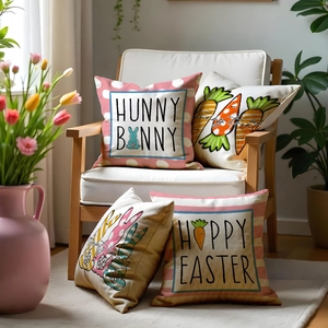 Detailed view of four linen Easter pillow covers with bunny patterns on a wooden chair
