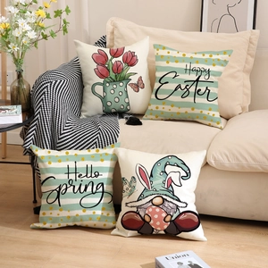Close-up of four Easter pillow covers with tulip and gnome prints on a cozy sofa