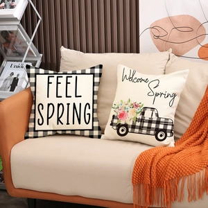 Linen Valentine decorative pillow cases with 'Spring' lettering on a modern sofa