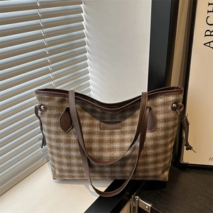 Retro checkered tote bag with woven fabric texture and brown faux leather straps