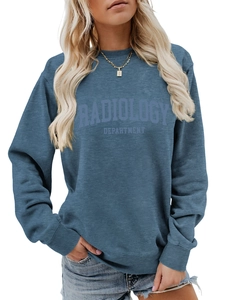 Detail of radiology department print on navy blue crewneck sweatshirt with gold necklace