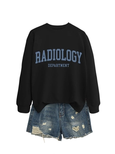Detail of radiology department print on black sweatshirt paired with ripped denim shorts