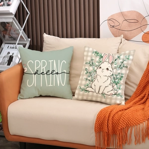 Easter decorative pillow covers set with cute rabbit and spring patterns on leather sofa