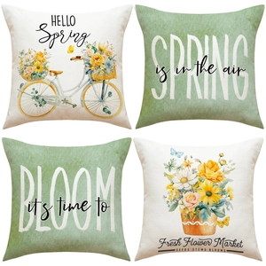 Close-up of four linen pillowcases with spring botanical prints and bicycle designs