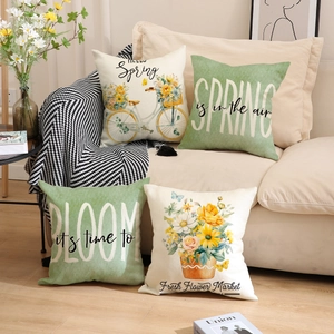 Detailed texture of spring theme linen pillow covers with green floral prints and bicycle