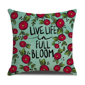 Detail of mint green floral pillow case with Live Life in Full Bloom text and fabric texture