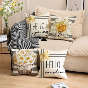 Set of four spring daisy print cushions with HELLO spring and bloom typography