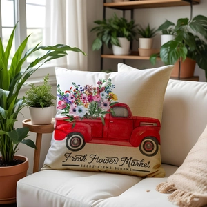 Vintage red truck floral pillow cover on sofa with indoor plants in bright natural light