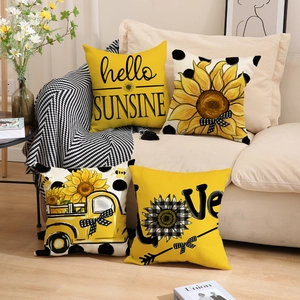 Set of 4 rustic sunflower pillow covers with vintage truck designs on a cozy sofa