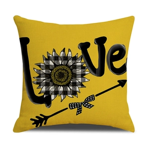 Detailed view of yellow floral cushion cover with plaid sunflower and LOVE typography