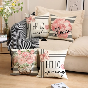 Detailed texture of 4-pack sunflower pillow covers on a sofa with floral lettering