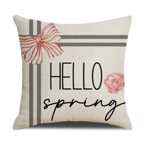 Detail of linen sunflower pillow cover with Hello Spring print and red ribbon bow