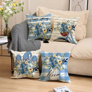 Détail de quatre housses de coussin en lin avec motifs floraux et gnomes bleus