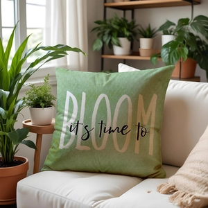 Green linen pillow cover with floral bloom print on white sofa with plants
