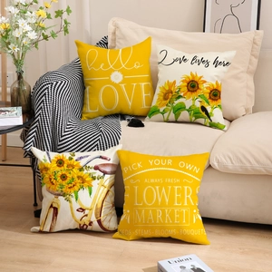 Detailed set of four yellow and beige linen pillows with sunflower and bicycle prints