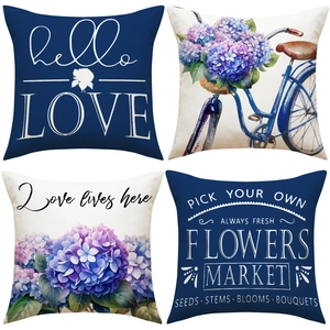 Detail view of four linen pillow covers with watercolor hydrangeas and vintage bike prints