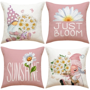 Detailed macro view of four linen pillow covers with gnome and daisy flower prints