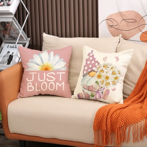 Detailed close-up of pink daisy and gnome pillows on a modern minimalist sofa