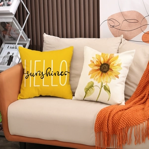 Sunflower decorative pillow covers with HELLO sunshine text on a cozy beige sofa