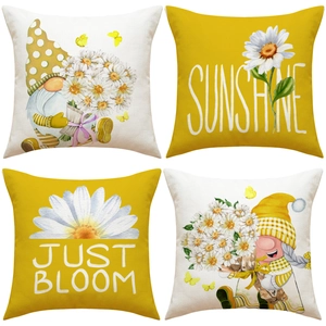 Close-up of linen pillowcases with gnome and sunflower watercolor designs and sunshine text