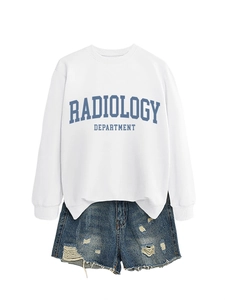Flat lay of white radiology department sweatshirt paired with distressed denim shorts