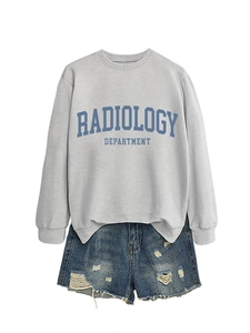 Detail of grey Radiology Department sweatshirt paired with ripped denim shorts