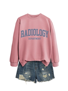 Detail of pink radiology department sweatshirt paired with blue distressed denim shorts