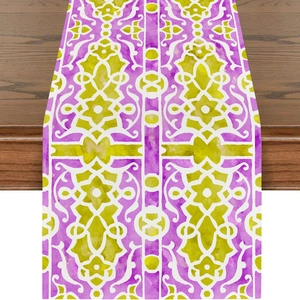 Detail of bohemian moon print table runner with purple and yellow geometric patterns