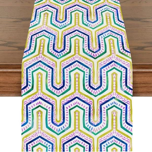 Detail of colorful geometric wave pattern on linen table runner over dark wood table