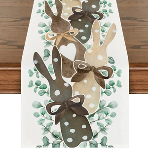 Detail of linen Easter table runner featuring cute bunny print and green eucalyptus leaves