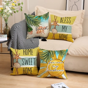 Set of four summer ocean pillows with starfish and shells on a modern beige sofa
