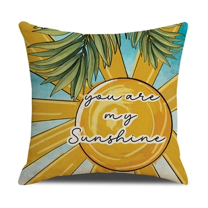 Detail of cotton linen pillow cover with yellow sun and green palm leaves print