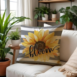 Sunflower bloom pillow case with striped pattern on sofa among green plants
