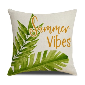 Detail of tropical palm leaf print and Summer Vibes text on linen throw pillow cover
