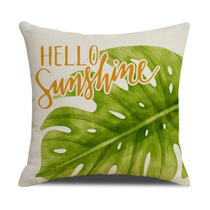 Detail of linen pillow cover featuring tropical monstera leaf and HELLO Sunshine print