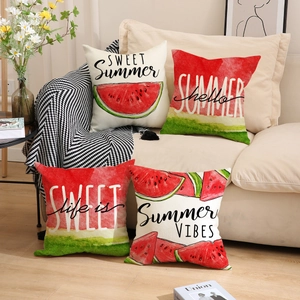 Set of four summer watermelon cushion covers on a beige sofa with vibrant prints