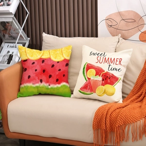 Close-up of summer watermelon and lemon print linen pillowcases on a white sofa