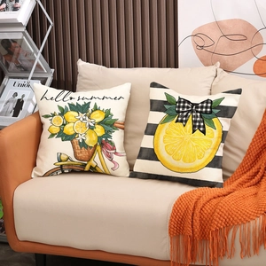 Modern set of two summer lemon theme cushion covers on a sofa with cozy home decor