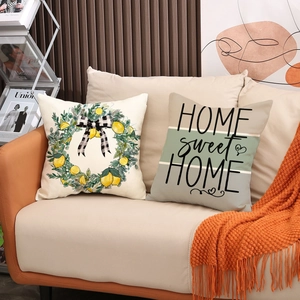 Linen pillow covers set with lemon wreath and Home Sweet Home print on leather sofa