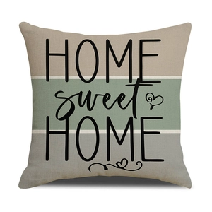 Detail of linen cushion cover with HOME sweet HOME print in morandi color blocking