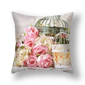 Detail of floral pillowcase featuring pink roses, hydrangeas, and vintage birdcages