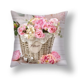 Detail of square cushion cover with floral print featuring pink roses in a woven basket