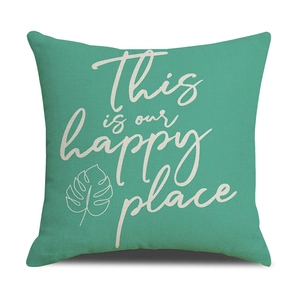 Close-up of mint green linen pillowcase with 'This is our happy place' text and leaf