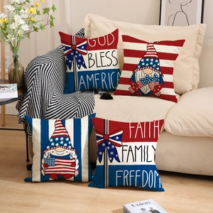 Set of four patriotic American gnome pillow covers in red, white and blue on a sofa
