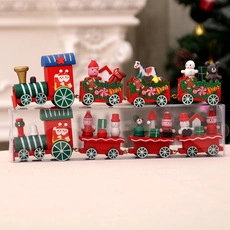 Close-up of hand-painted wooden Christmas train ornaments with Santa and snowman figures