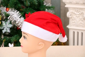 Detail view of high-quality velvet Santa hat with white plush ball and trim on mannequin