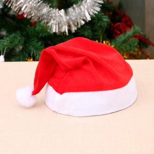 Classic red and white plush Christmas hat for adults and kids on a festive background